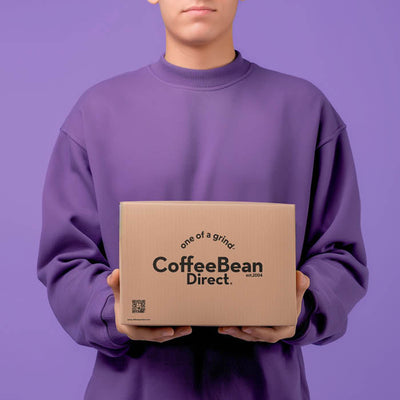 Coffee Bean Direct Roaster's Blend 3-Month Gift Subscription -- customer holding one Coffee Bean Direct delivery box with coffee