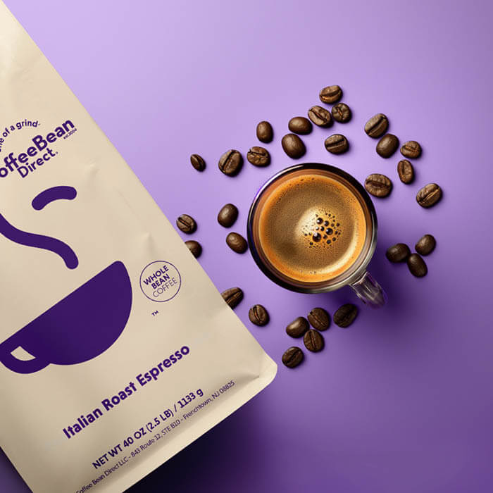 Coffee Bean Direct Espresso Subscription -- Italian Roast Espresso coffee bag alongside mug of espresso and scattered coffee beans