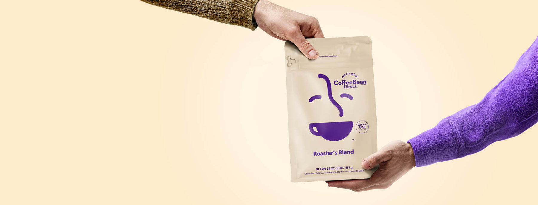 Give a Subscription -- person handing bag of Coffee Bean Direct Roaster's Blend to another person