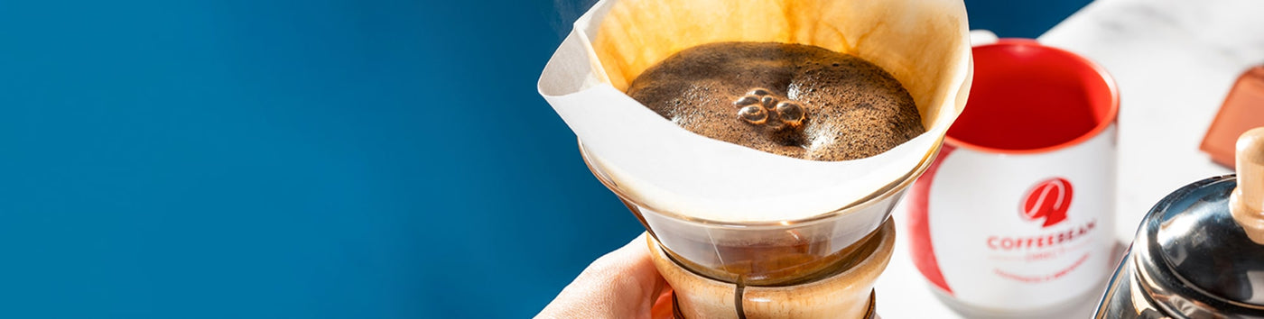 Gift Subscription hero -- glass pourover with coffee filter on top and coffee mug
