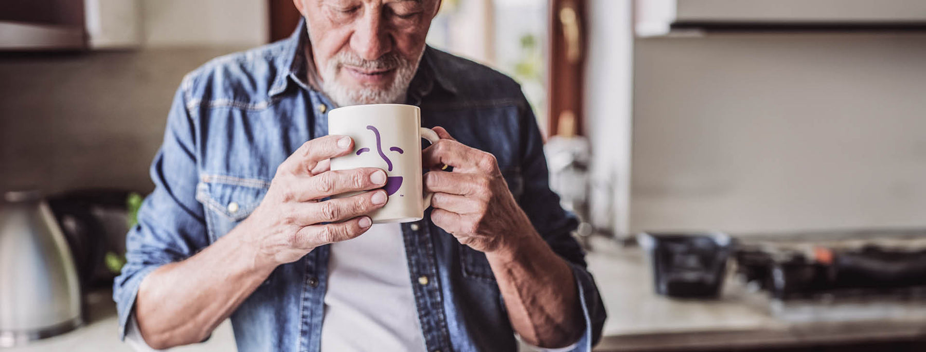 Gift Subscription Landing Page secondary image -- Treat Yourself -- man holding a Coffee Bean Direct coffee mug