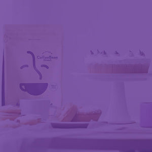 Anniversary Blend featured mobile hero -- table containing bag of Coffee Bean Direct coffee, assorted pastries, cake, and a coffee mug