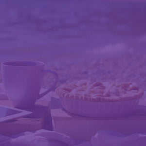 Apple Pie a la Mode featured mobile hero -- beach shore setup with towel, tablet, mug of coffee, and apple pie resting on a book