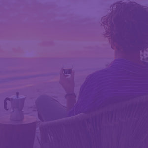 Espresso Subscription featured mobile hero -- person watching a beach sunrise while sitting in a chair holding a shot of espresso