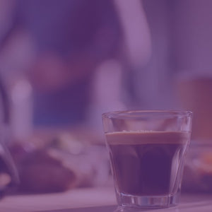 Godfather's Italian Espresso featured mobile hero -- close-up of a shot glass with espresso over a blurred background