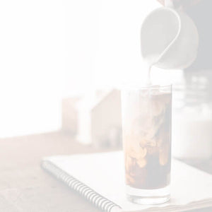 Iced Coffee Blend featured mobile hero -- glass of iced coffee resting on a notepad on a desk