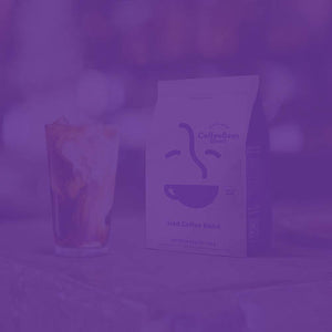 Iced Coffee Blend featured mobile hero -- tall glass of iced coffee with cream and ice cubes resting on table next to Coffee Bean Direct bag