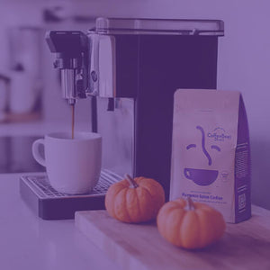Pumpkin Spice featured mobile hero -- kitchen counter with coffee maker, coffee mug, and small pumpkins on a wooden cutting board alongside a bag of coffee