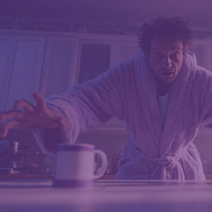 Zombie Cure featured mobile hero -- man in bath robe reaching for coffee in the kitchen with eyes wide open