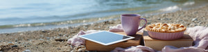 Apple Pie a la Mode featured hero -- beach shore setup with towel, tablet, mug of coffee, and apple pie resting on a book