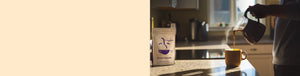 Ethiopian Yirgacheffe featured hero -- person pouring coffee from a pot into a mug on a kitchen table, with a bag of Coffee Bean Direct coffee nearby