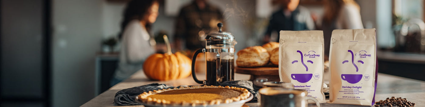Thanksgiving Sale featured hero -- Pumpkin pie on a table with french press coffee and  Coffee Bean Direct coffee bags 