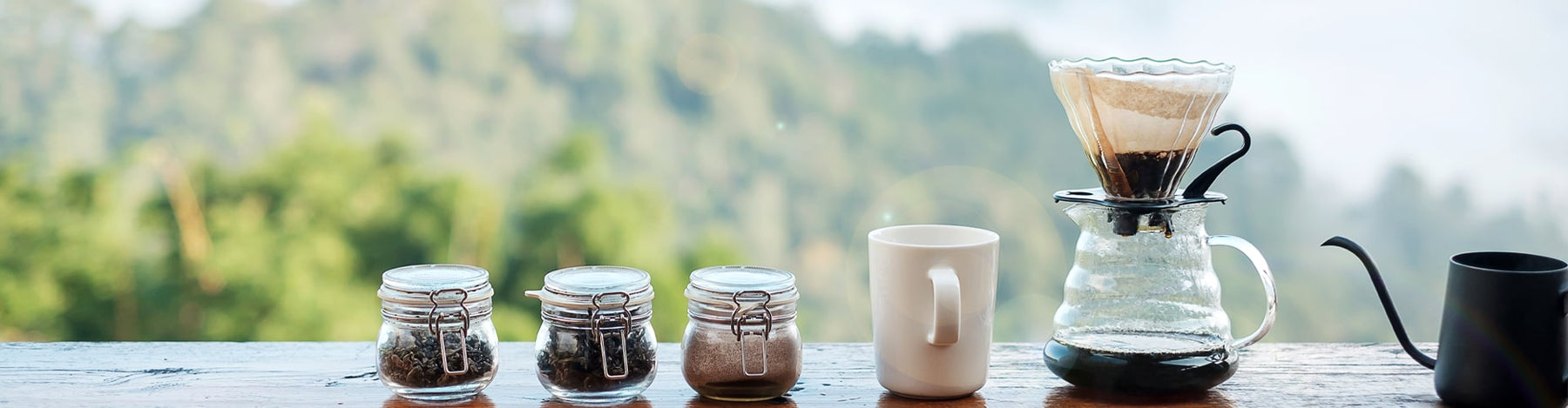 Glass storage jars with ingredients, coffee mug, and pourover